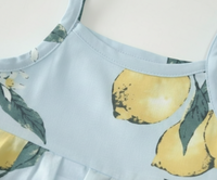 Close-up view of lemon print detail on Baby Girls Zesty Lemon Tiered Cotton Frock