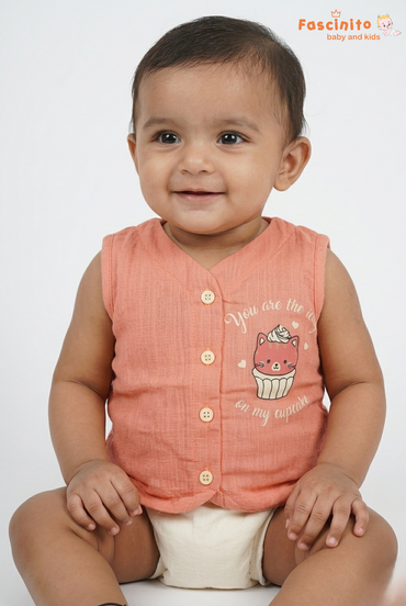 Baby wearing a peach cupcake print sleeveless jhabla top with front button closure