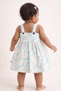 Back view of girls floral woven sleeveless cotton frock with all-over floral print