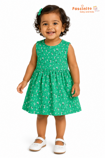 Toddler girl wearing green sleeveless floral frock on white background